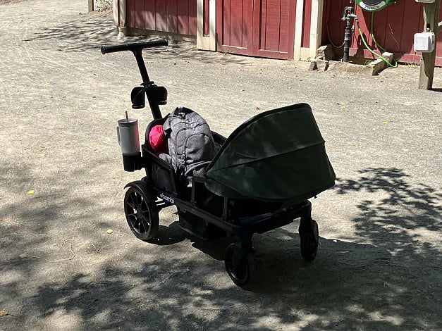 Green Waggle wagon loaded with bags and drinks at an outdoor event